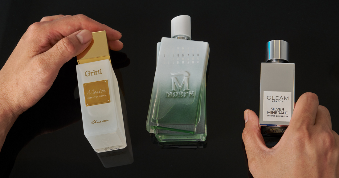 Three different perfumes part of a scent wardrobe against a black background.