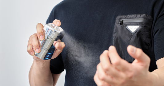 A man spraying Bentley for Men Silverlake Eau de Parfum on his wrist.