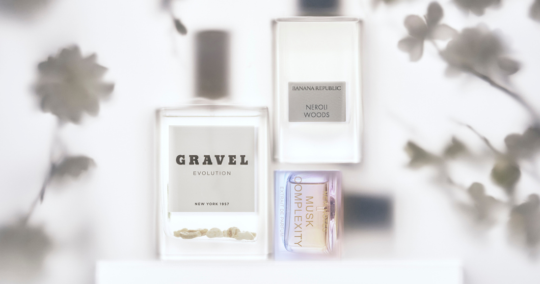 A collection of floral frangrances from So Avant Garde against a white background with shadowed flowers.