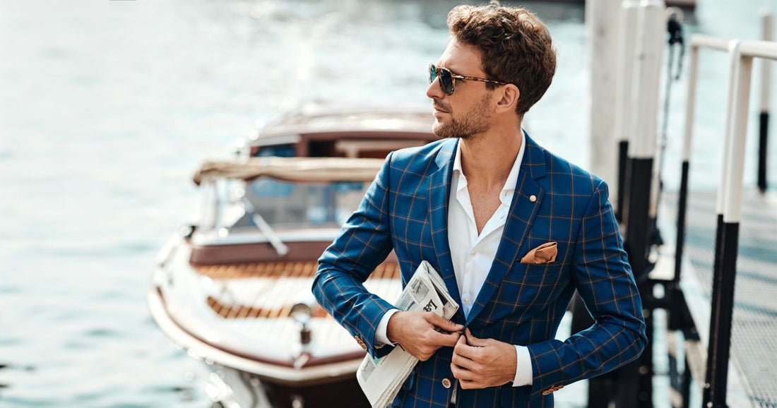A man wearing a blue suit looking like a celebrity while steppping off a boat.